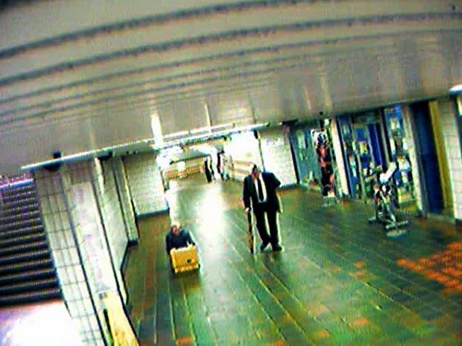 !Mediengruppe Bitnik - Still from Surveillance Chess showing Bitnik with yellow suitcase in Charing Cross subway station