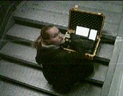 !Mediengruppe Bitnik - Still from Surveillance Chess showing Bitnik sitting with yellow transmission suitcase